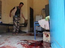 A Yemeni man inspects an elderly care home after it was attacked by gunmen in the port city of Aden, Yemen, Friday, March 4, 2016. Unidentified gunmen stormed a retirement home run by Catholic nuns in the southern city of Aden on Friday shooting more than a dozen people to death, including several Indian nuns, Yemeni security officials and witnesses said. (AP Photo/Wael Qubady)